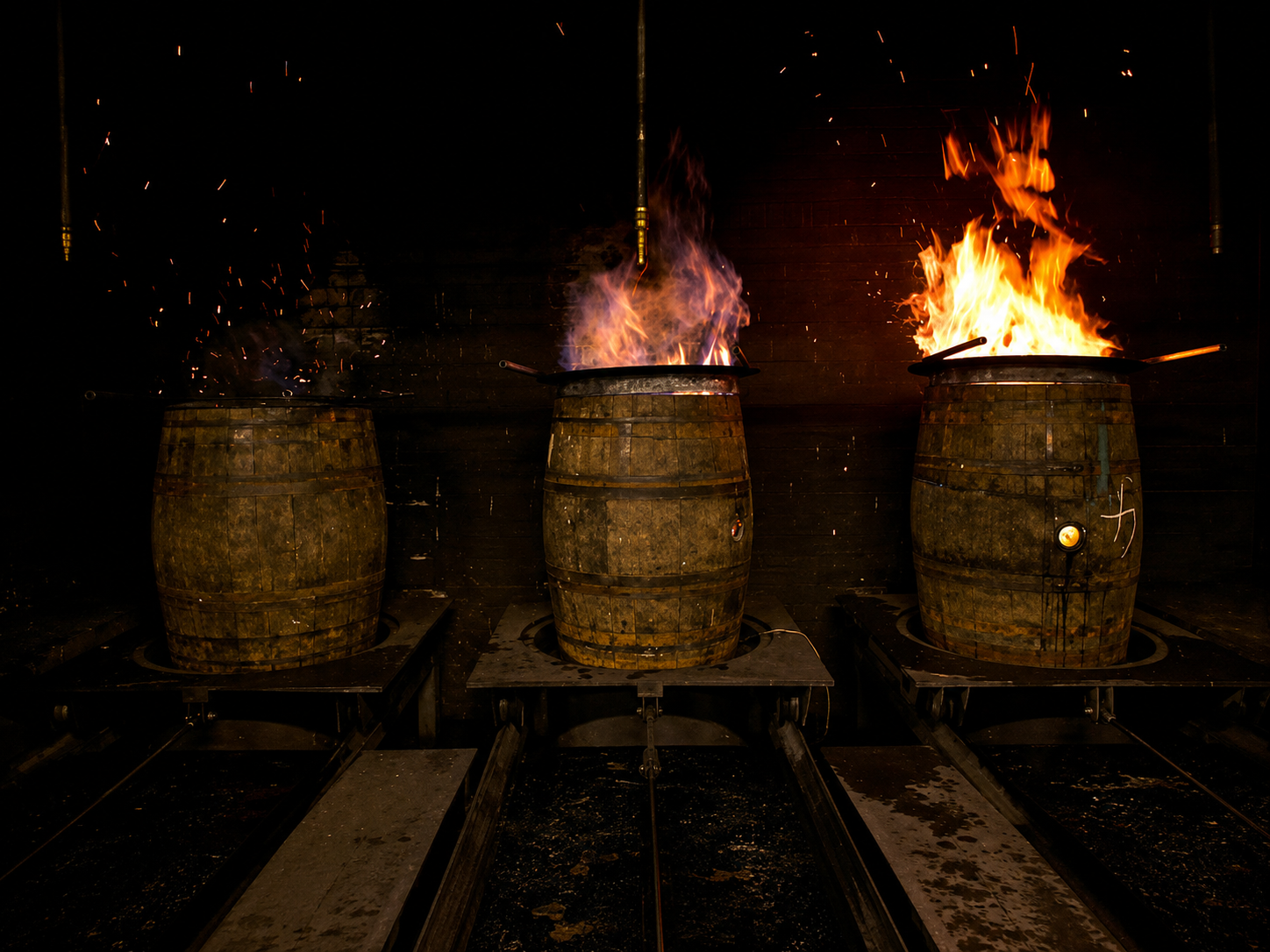 Oak casks undergoing heat treatment during cooperage