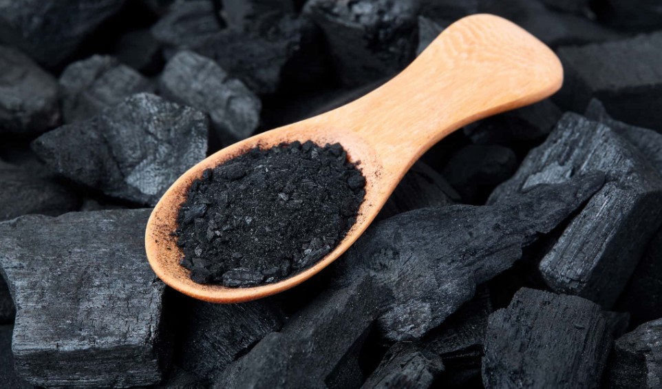 Activated carbon shown as black granules and powder
