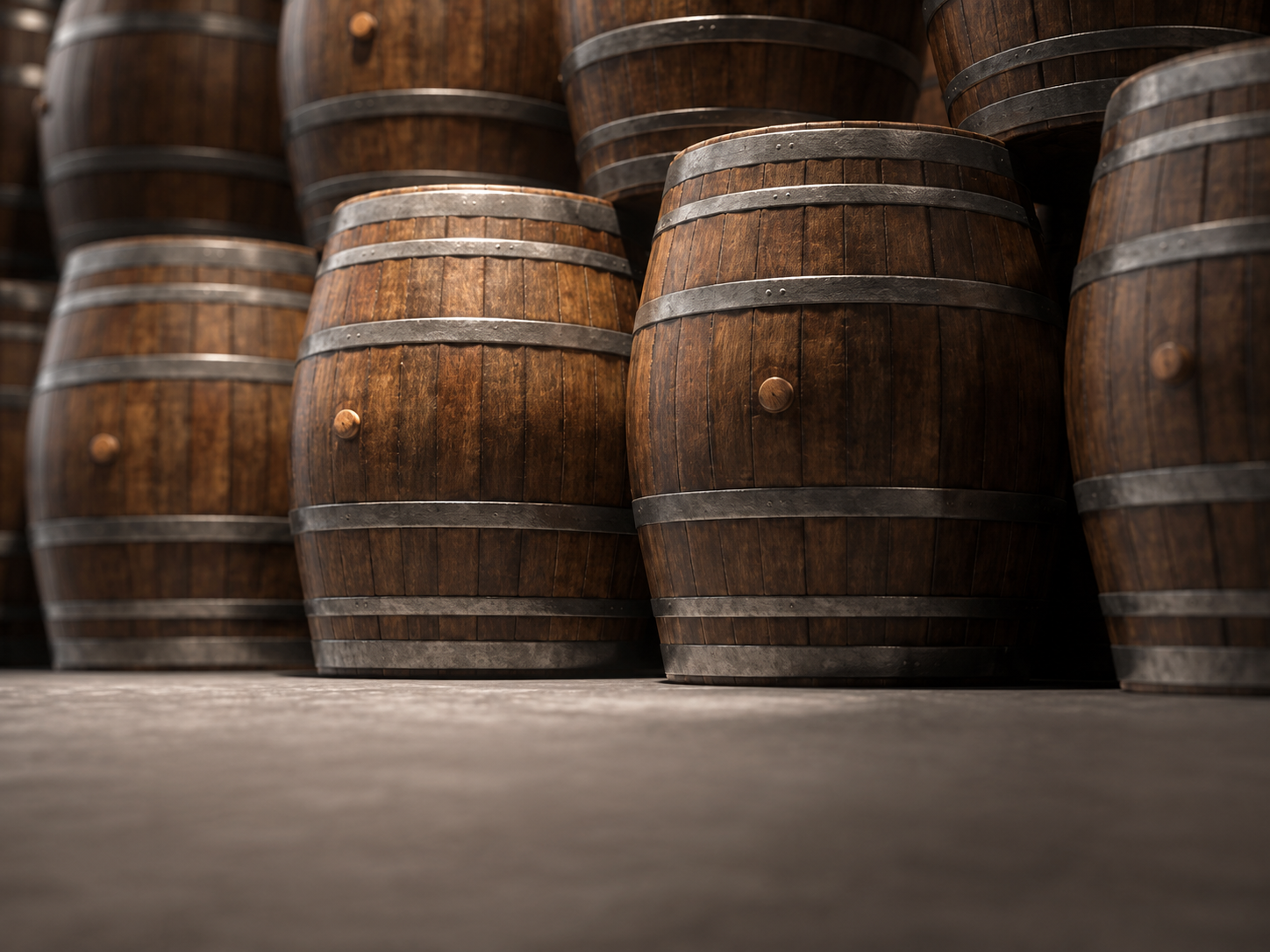 Rows of previously used whiskey barrels in storage