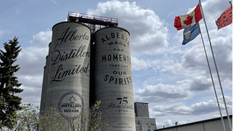 Alberta Distillers grain silos with Canadian flag