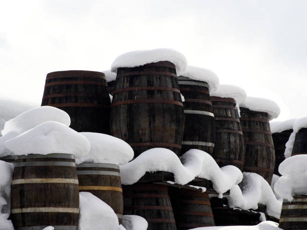 Wooden whisky barrels covered with snow