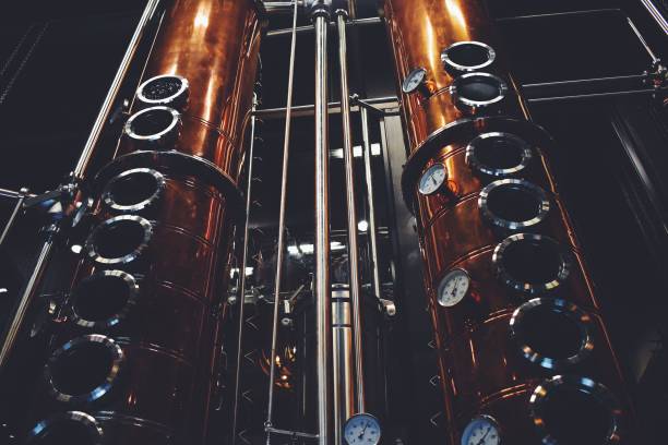 Tall copper rectification columns viewed from below
